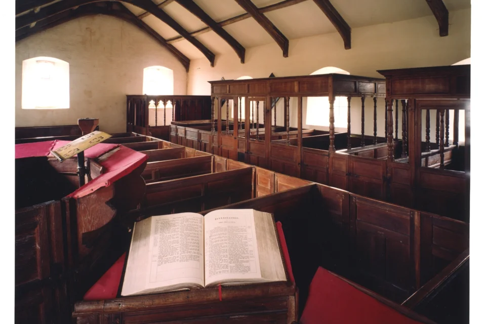box pews, and family pews with canopies, an elegant screen, and a three-decker pulpit.