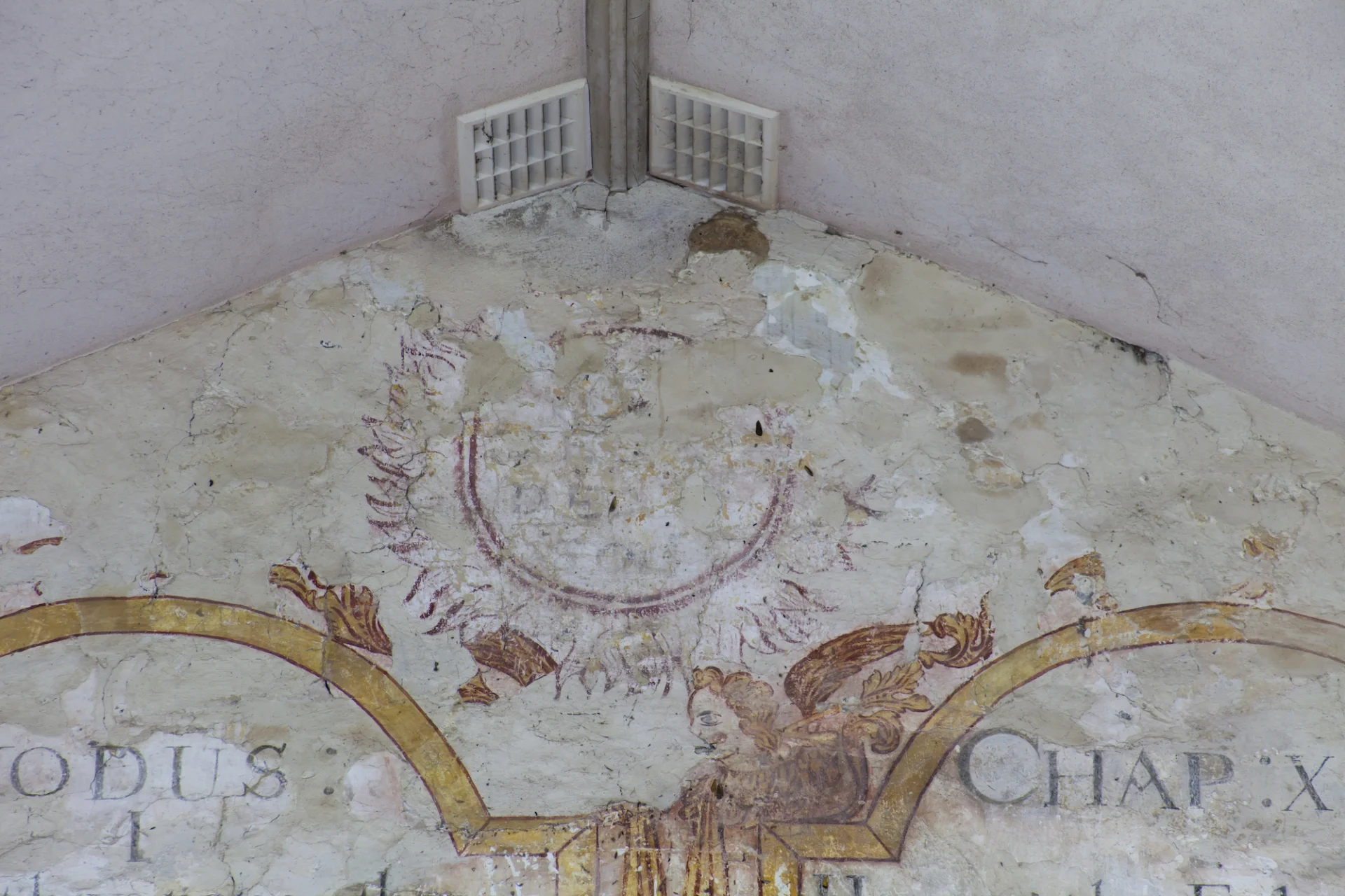 red stylistic sun wallpaintings with face above written extracts from Exodus.