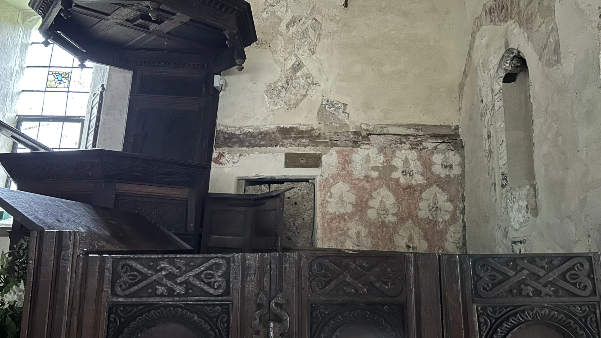 St James' Church, Cameley - interior showing the jester wallpainting right of pulpit with brocade design below