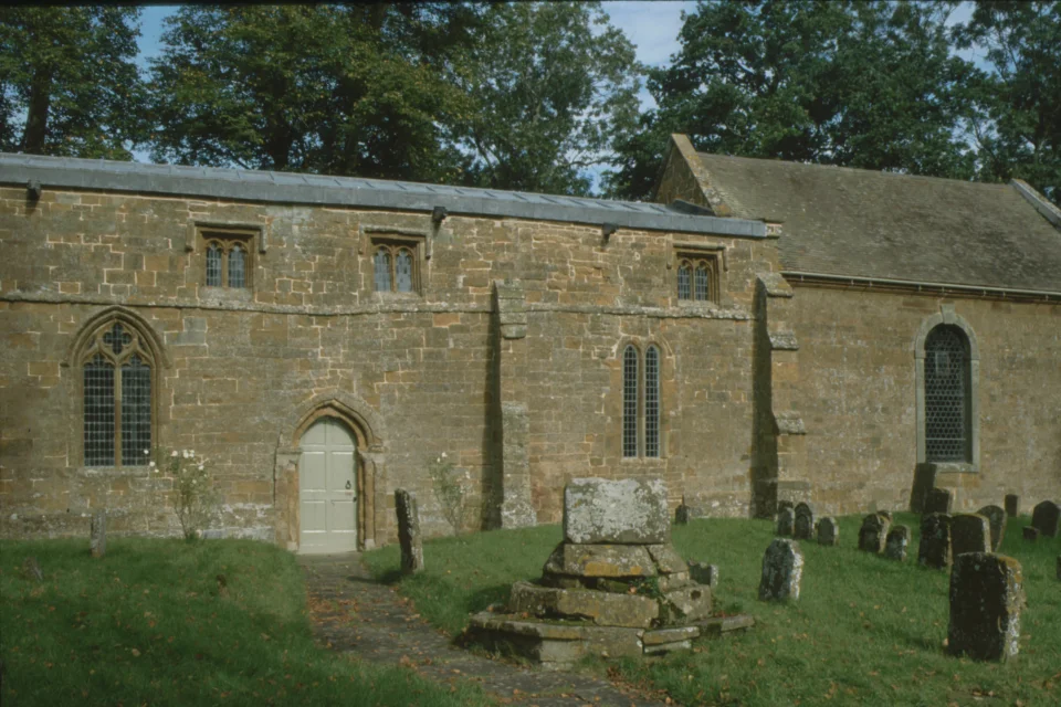 stone church exterior clearly showing extension with lower roof.