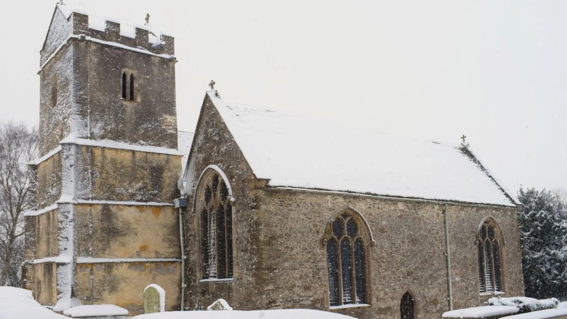 Exterior of St James' Church, Charfield, covered in snow