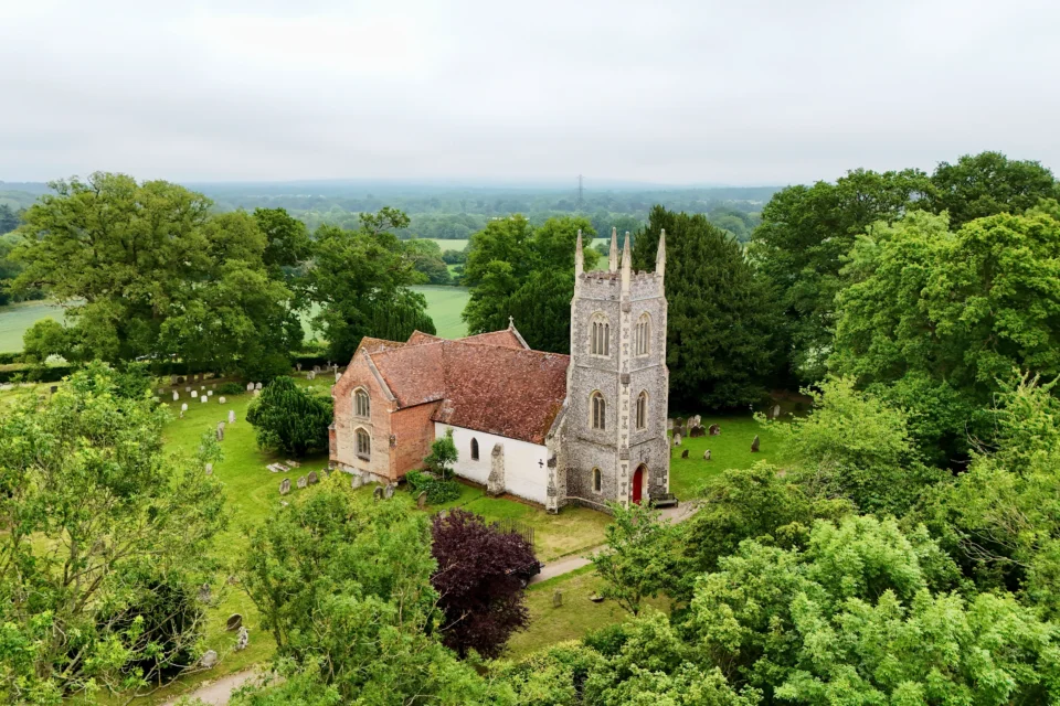 St Marys Hartley Wintney drone photograph in misty landscape scene