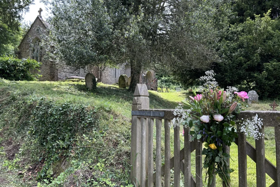 flowers on the entrance gate to Elworthy Church