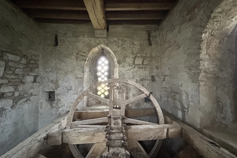 The wooden bell mechanism (wheel) inside the stone tower