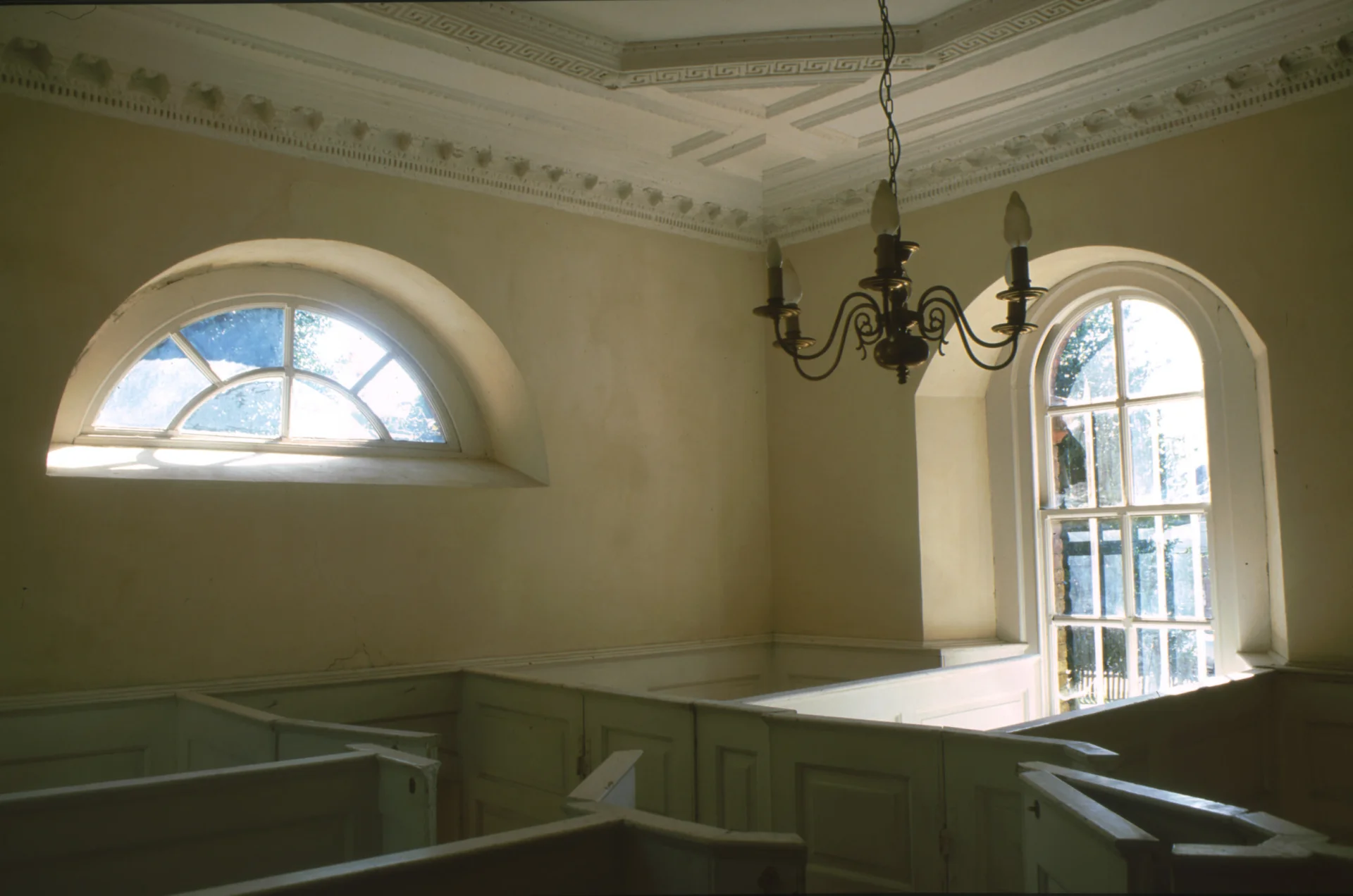 Inside the chamber pew with boxed pews and 2 exterior windows.