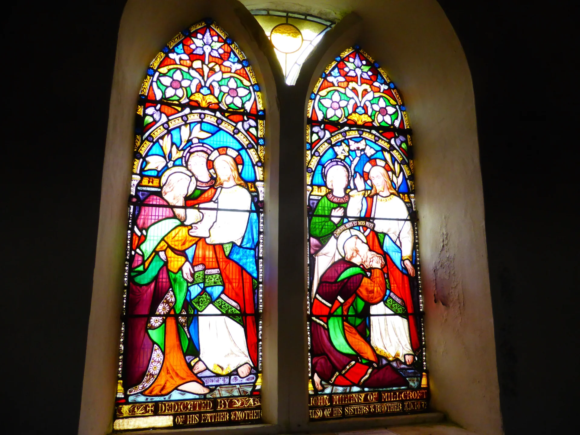 A gloriously colourful window depicting Jesus and his followers. This is how the window appeared prior to damage.
