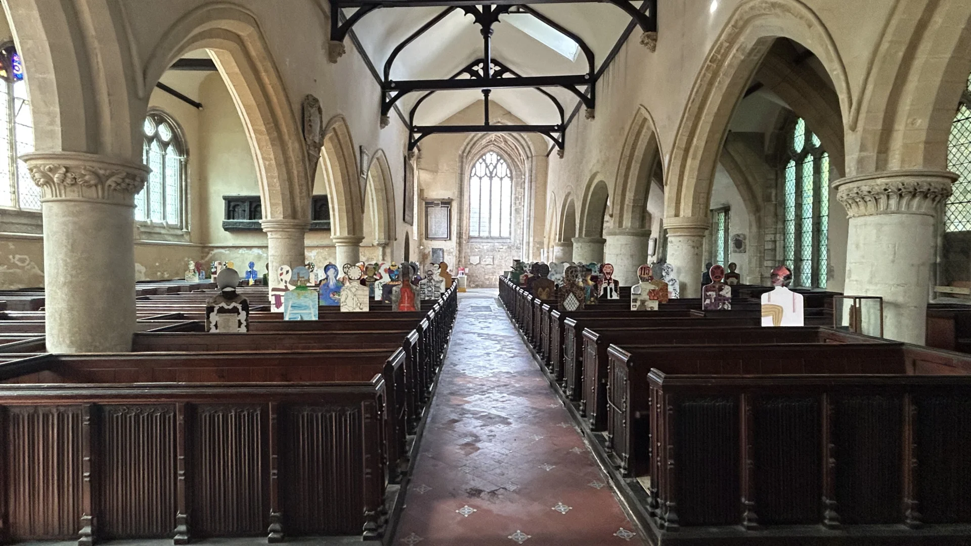 Nave of St Nicholas Gloucester, showing decorated silhouettes representing  residents who used the church historically