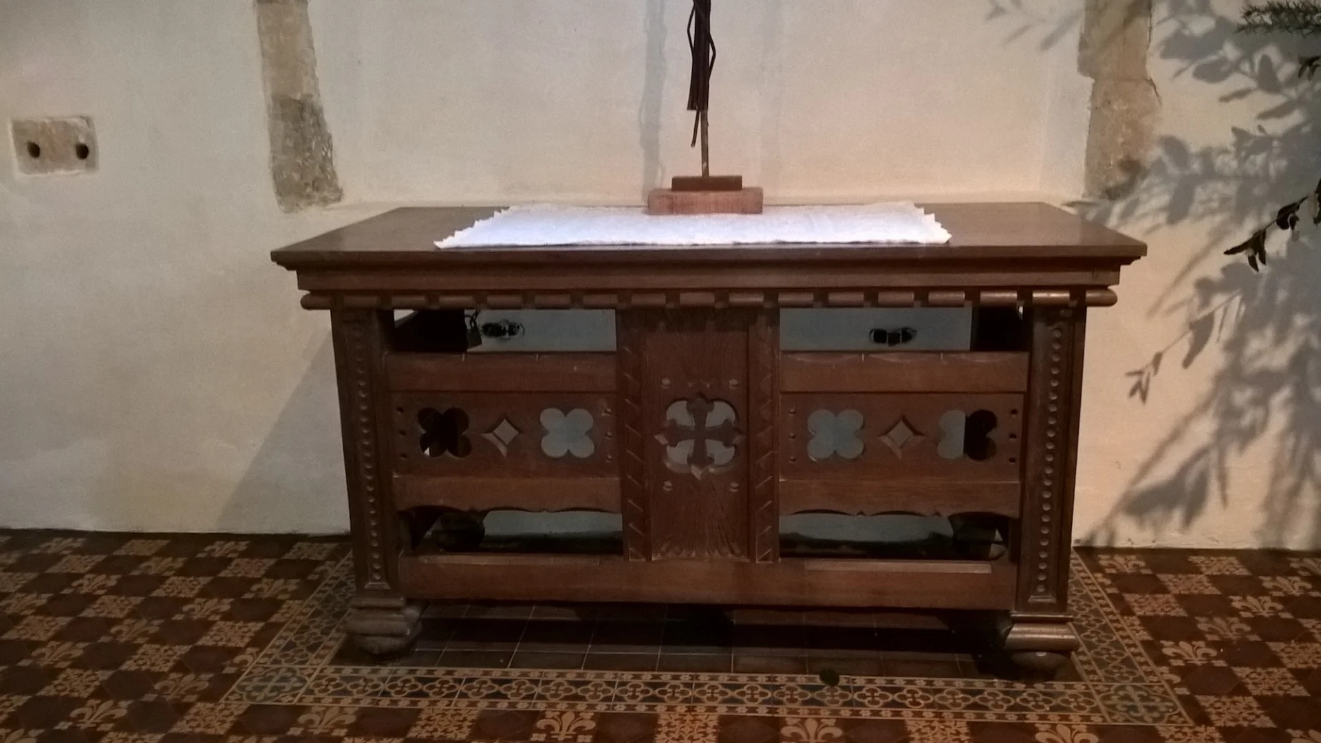 Wooden altar with decorative cross and flower design cut outs