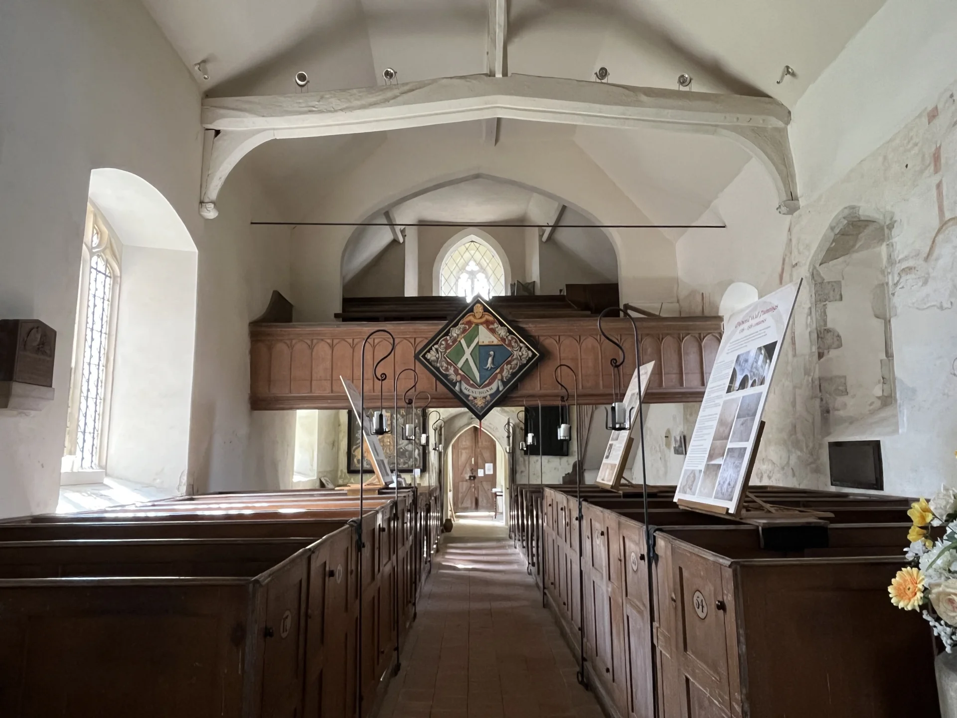 Interior of St Mary's in Hartley Wintney with interpretation boards and lighting.