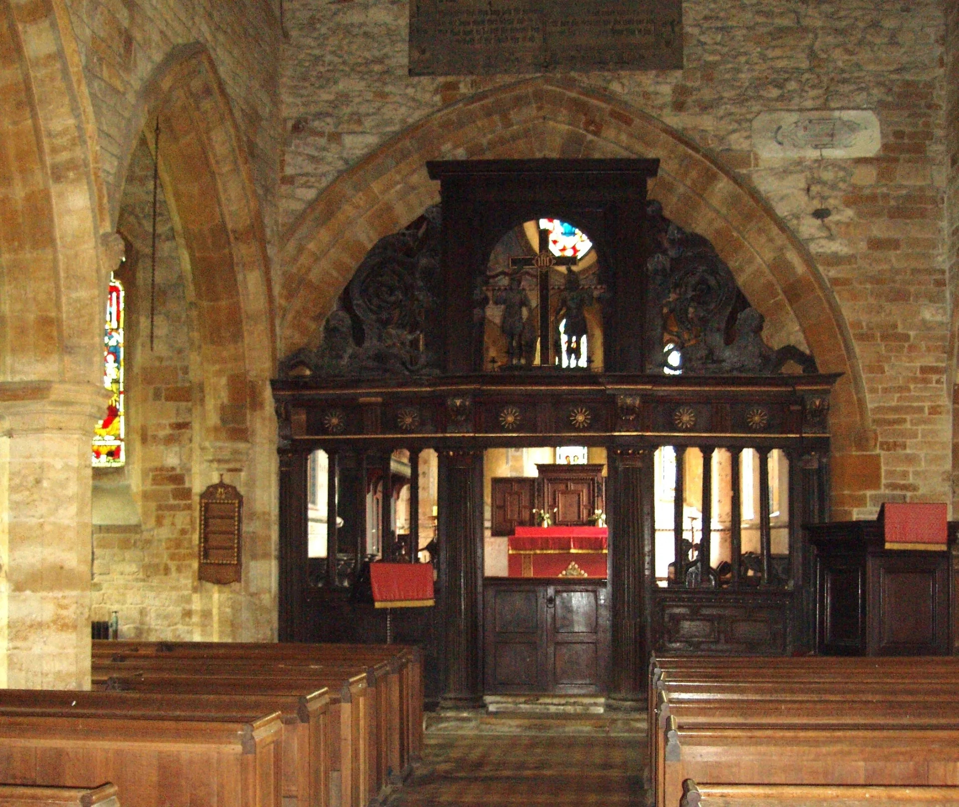 Decorative wooden screen within Holdenby including carved statues on screen