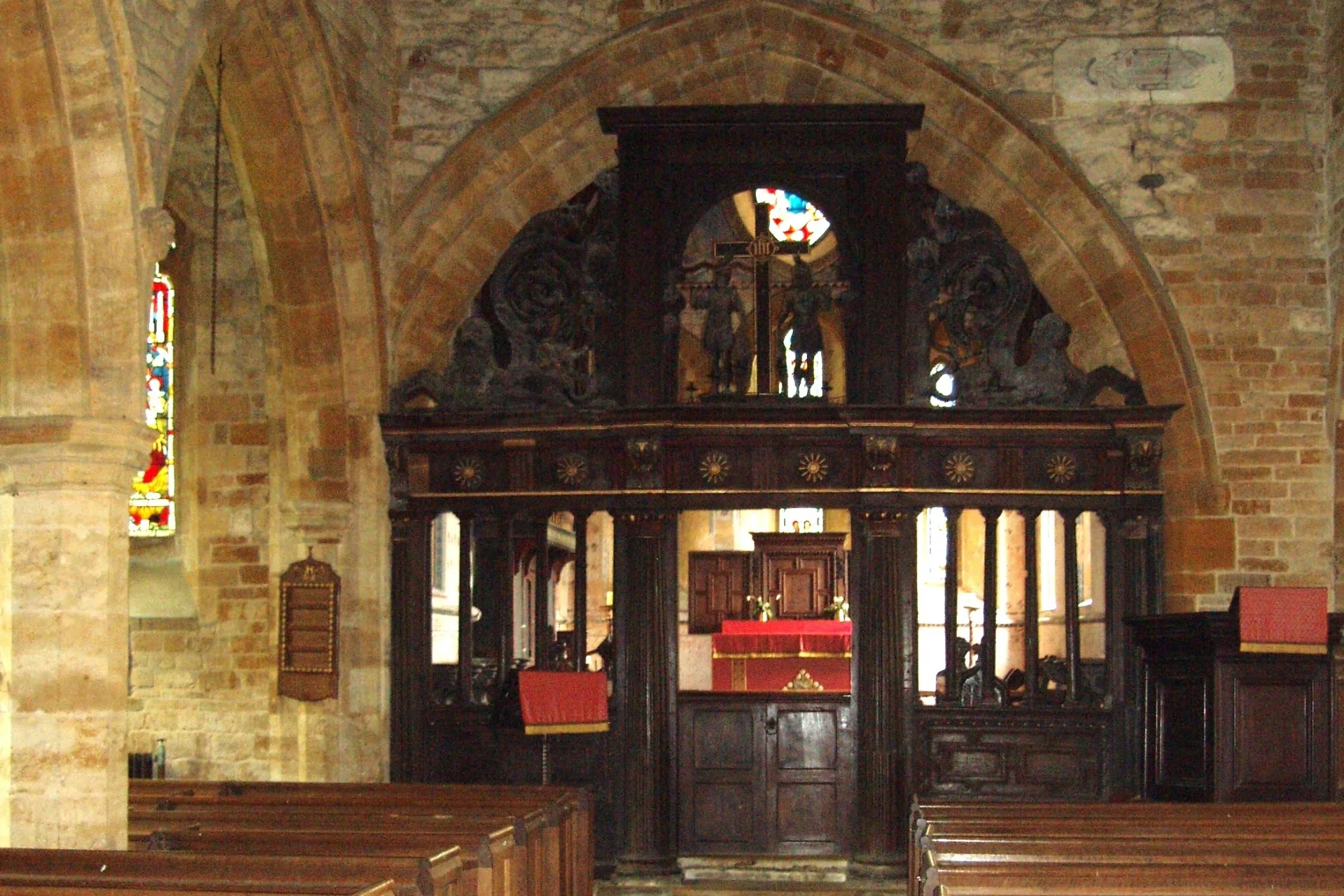 Decorative wooden screen within Holdenby including carved statues on screen