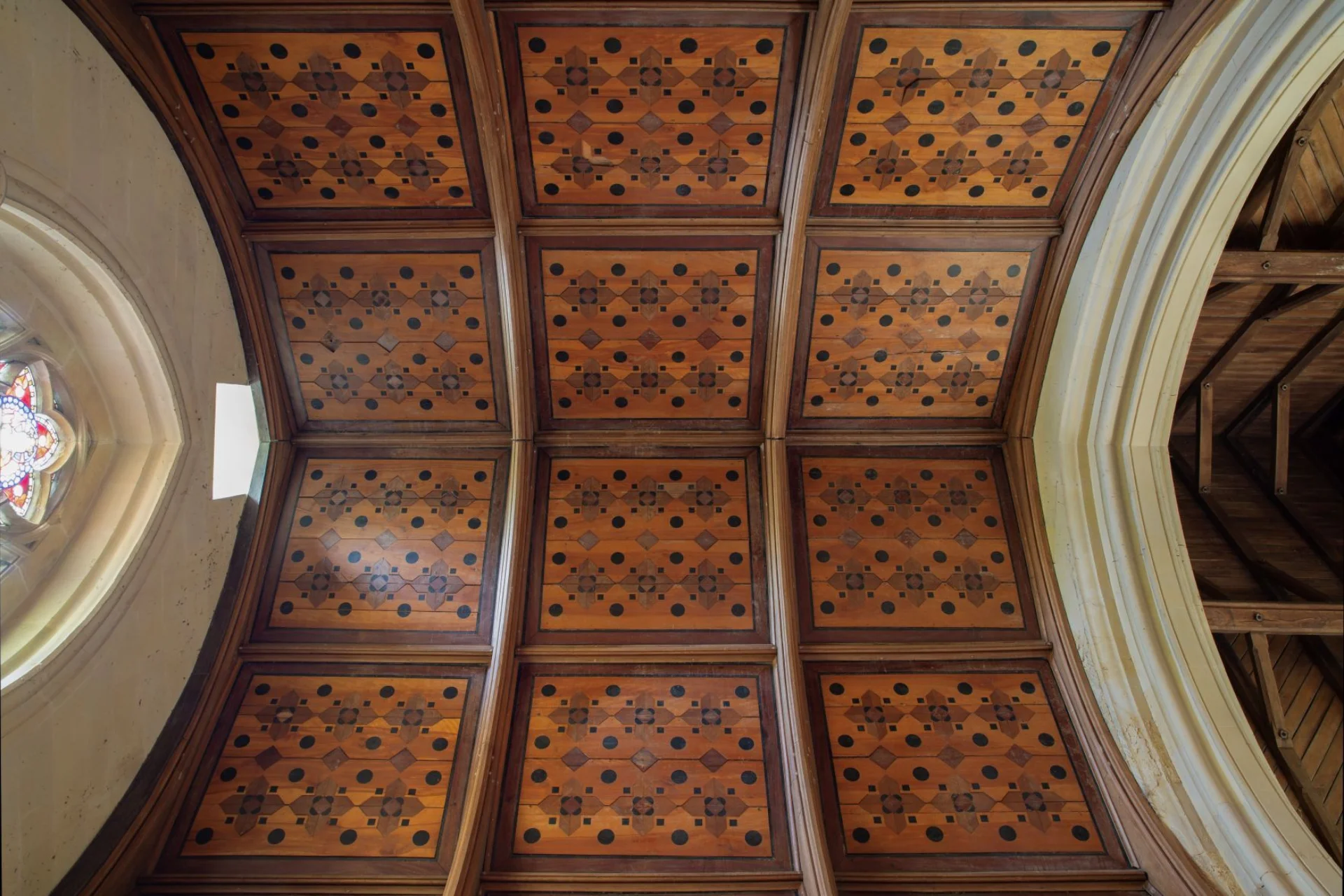 Wooden ceiling painted to look like it has cross-shaped inlays.
