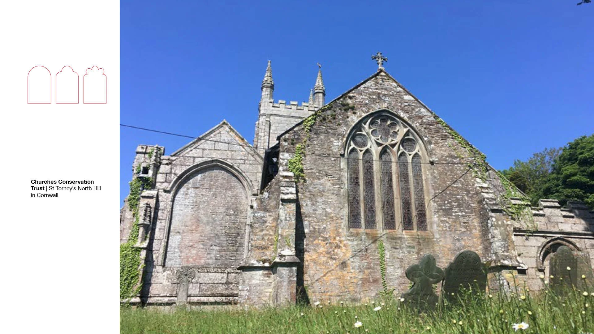 Showing the exterior of the rear of the church, featuring a large stained glass window and a large blocked out window.
