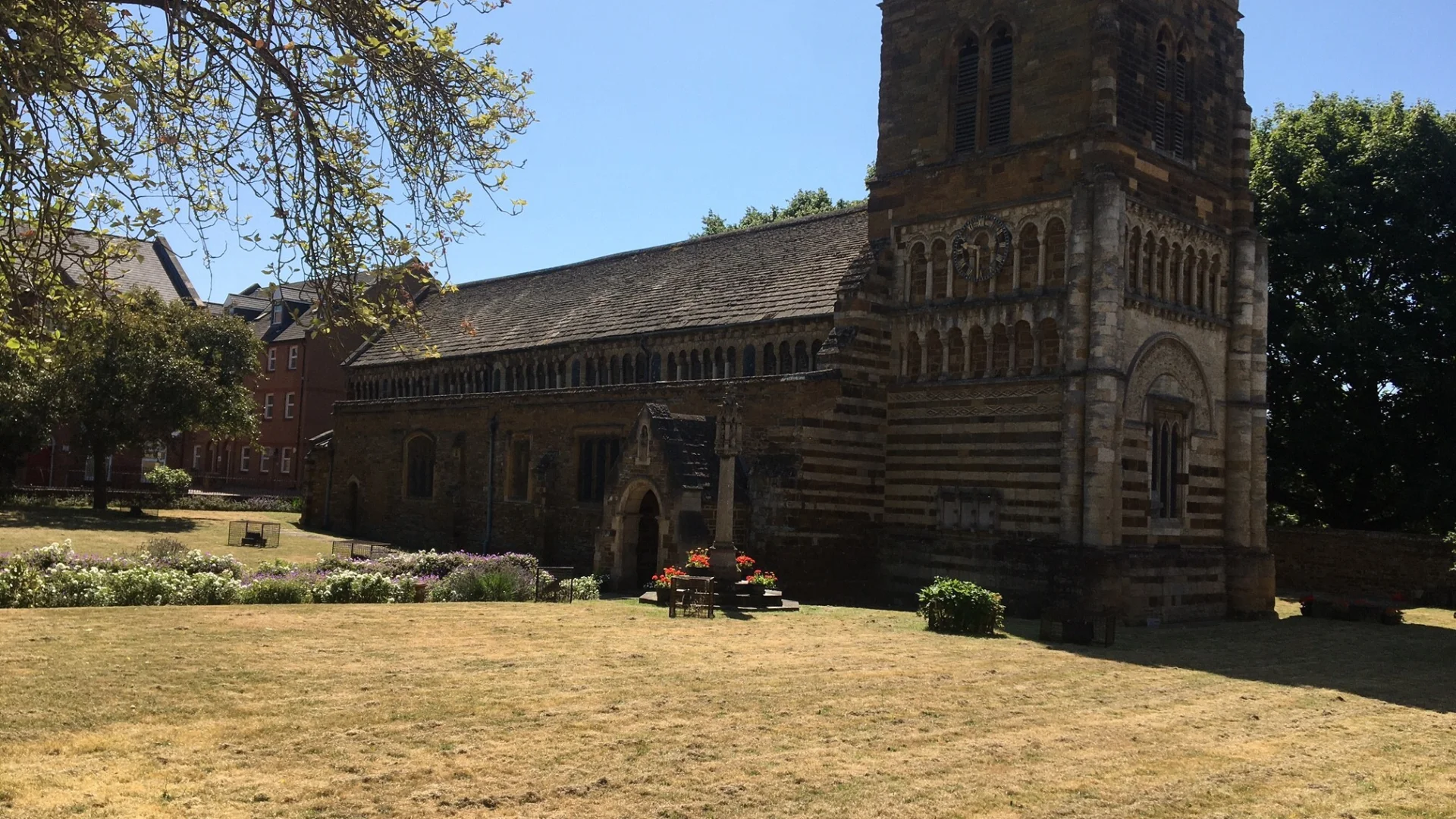 Side view of the exterior of the stone and brick built church