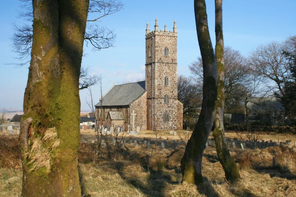 External view of the stone built church through the trees