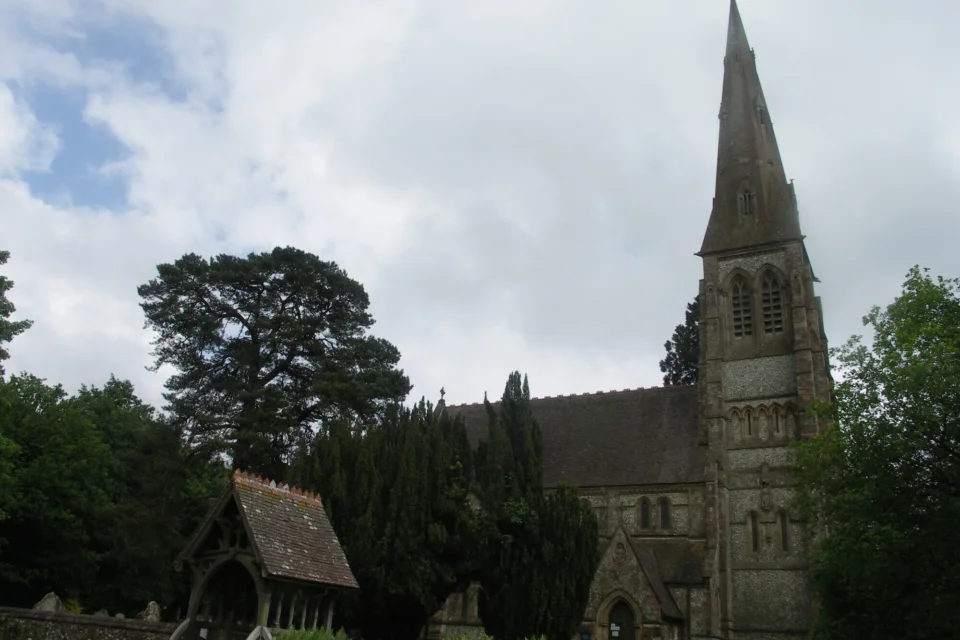 External side view of the light grey stone built church