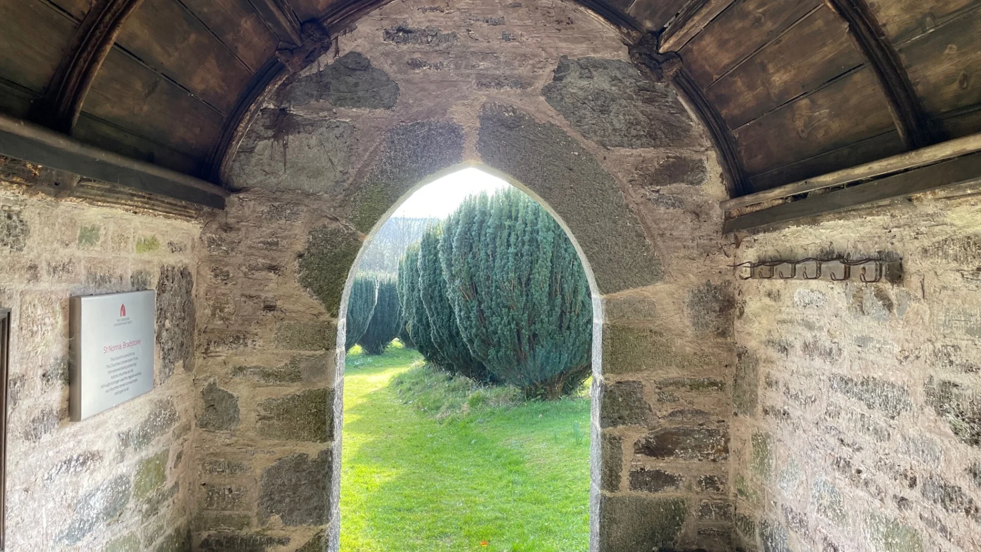 Bradstone Porch looking out into grounds with row of yew trees in distance