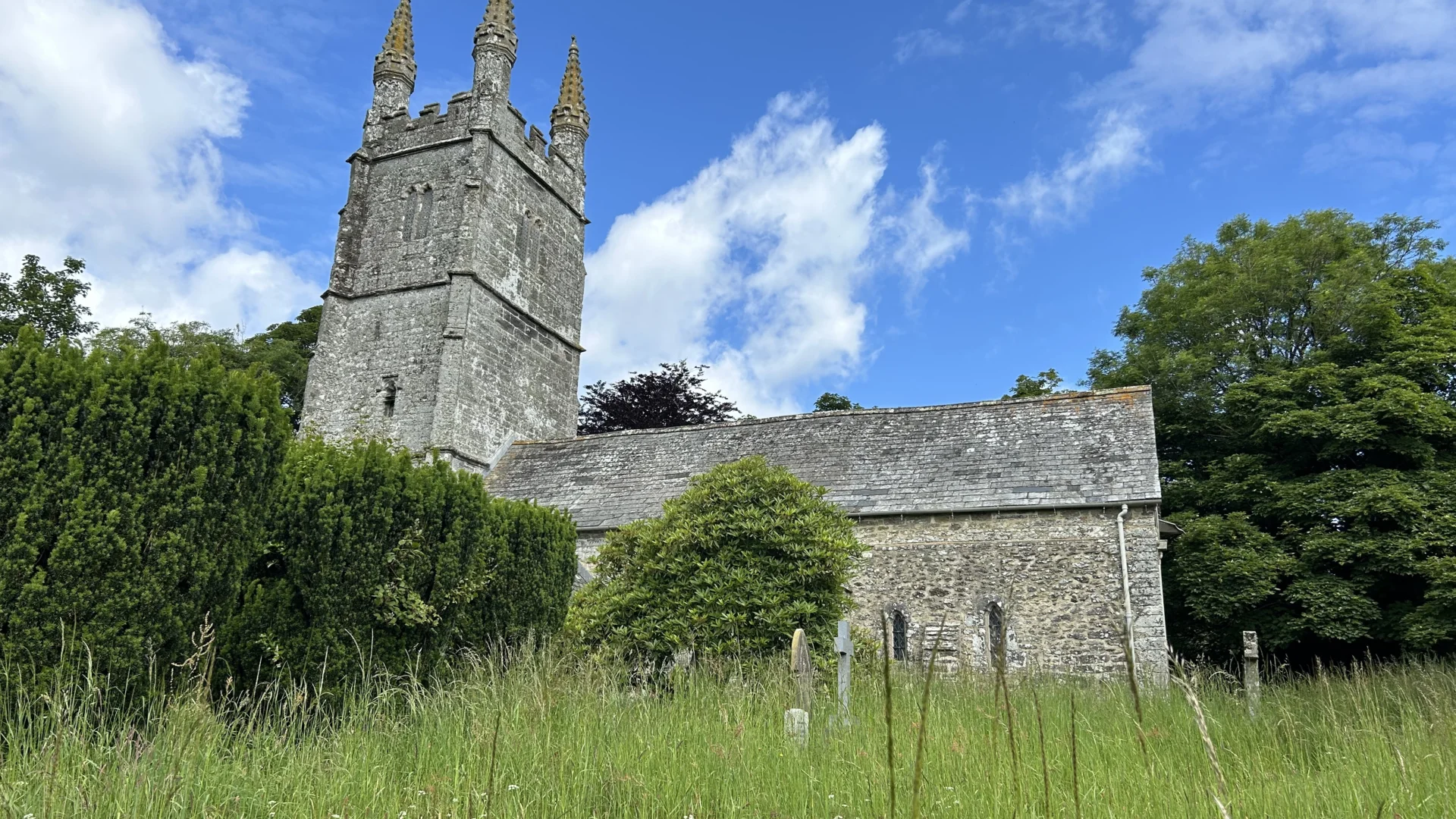 Bradstone Church exterior with grass in foreground and blue sky above