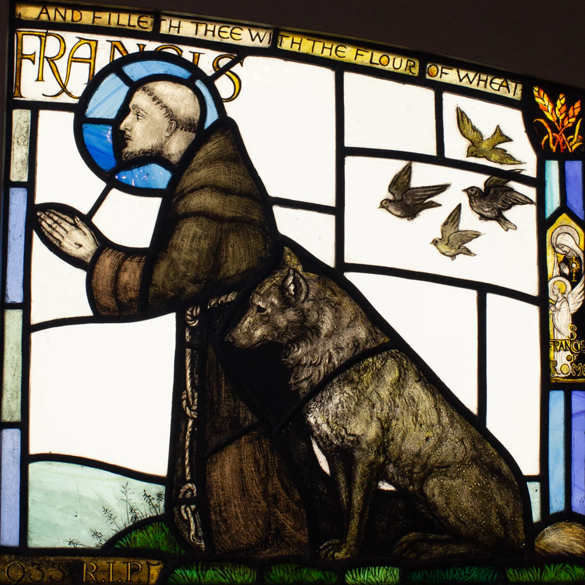 Francis of Assisi kneeling in prayer, next to him sits a big wolf.