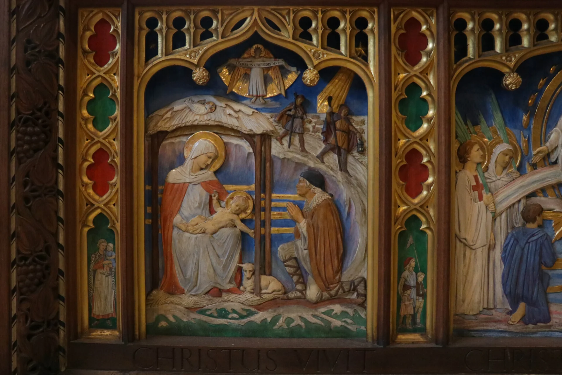 A carved image of the nativity painted in vibrant colour.