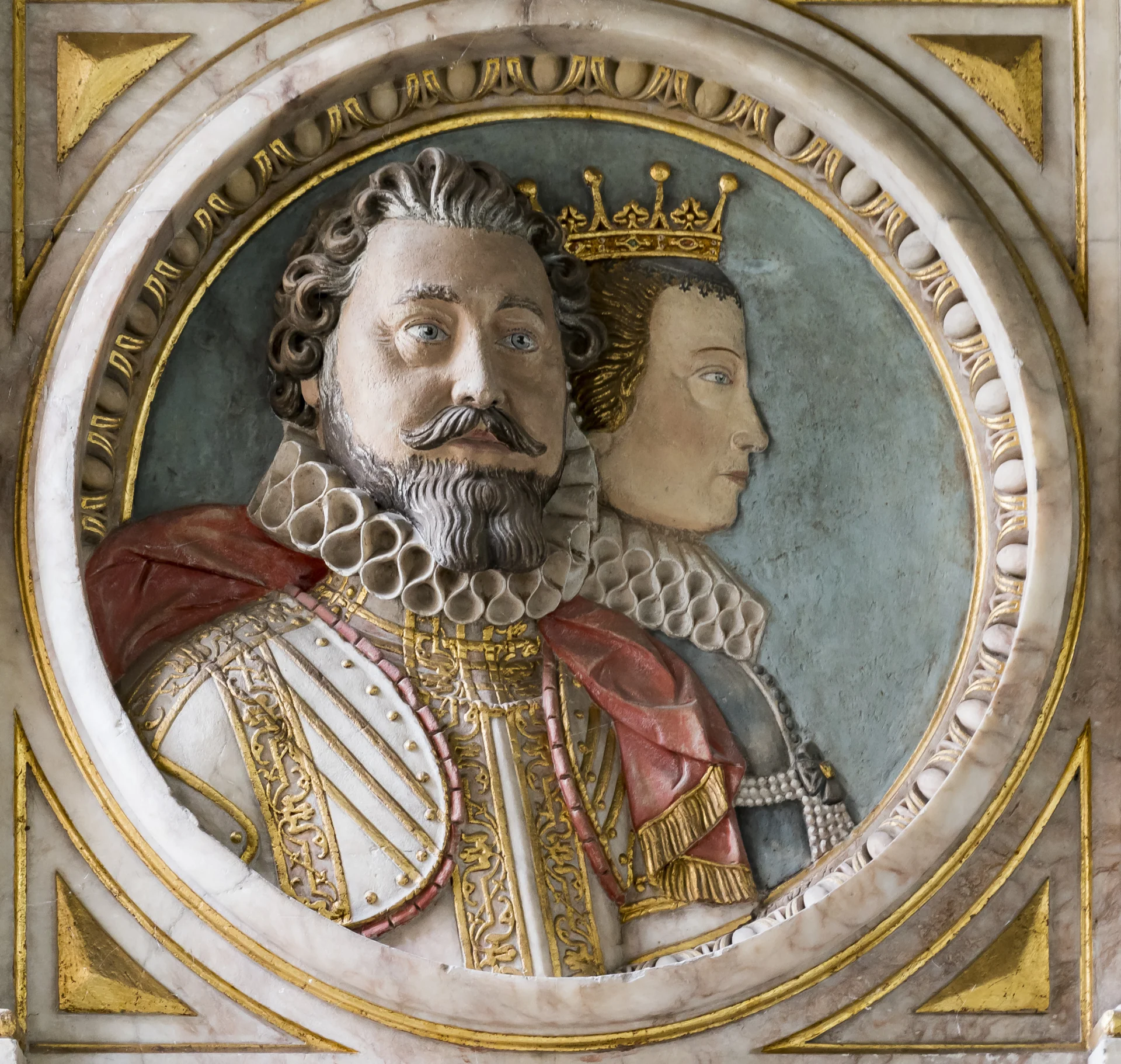 A wall colourful tablet depicting Robert Rich and Frances Wray, Earl and Countess of Warwick in relief.