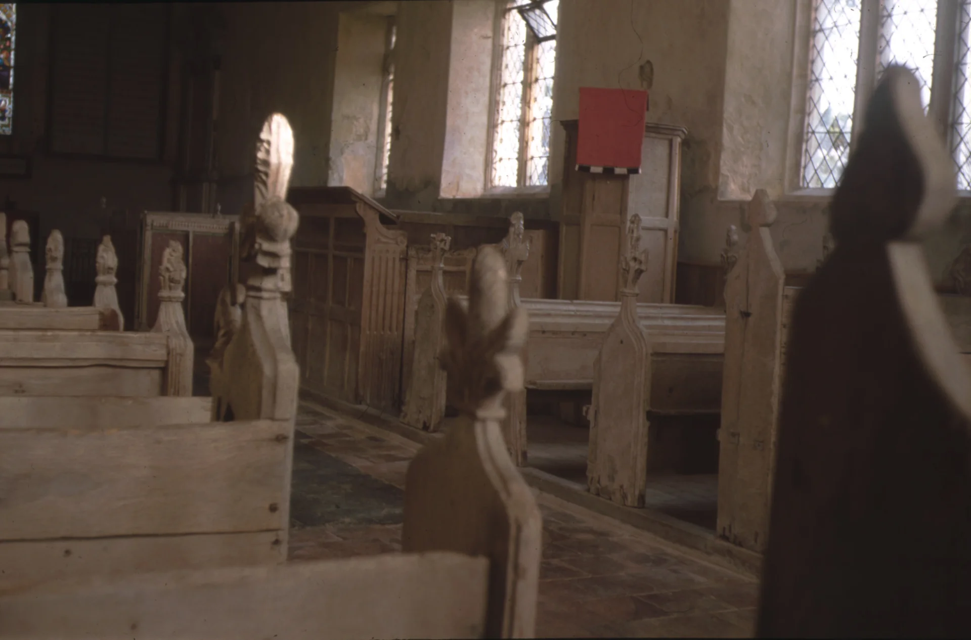 light wooden Pews with medieval flower design poppyhead