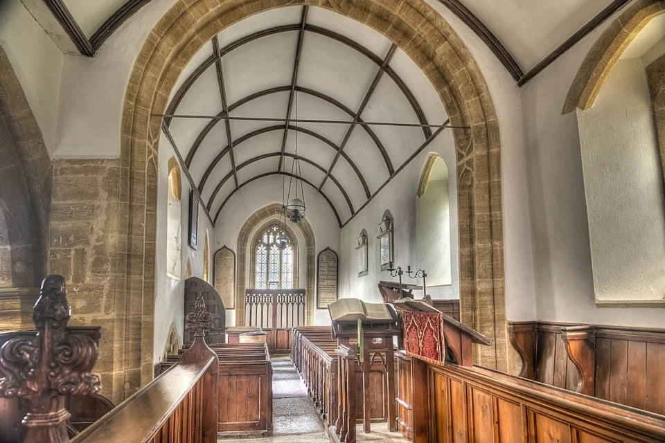barrel roof of nave, with photo taken from the altar the choir stalls with poppyheads are also shown.