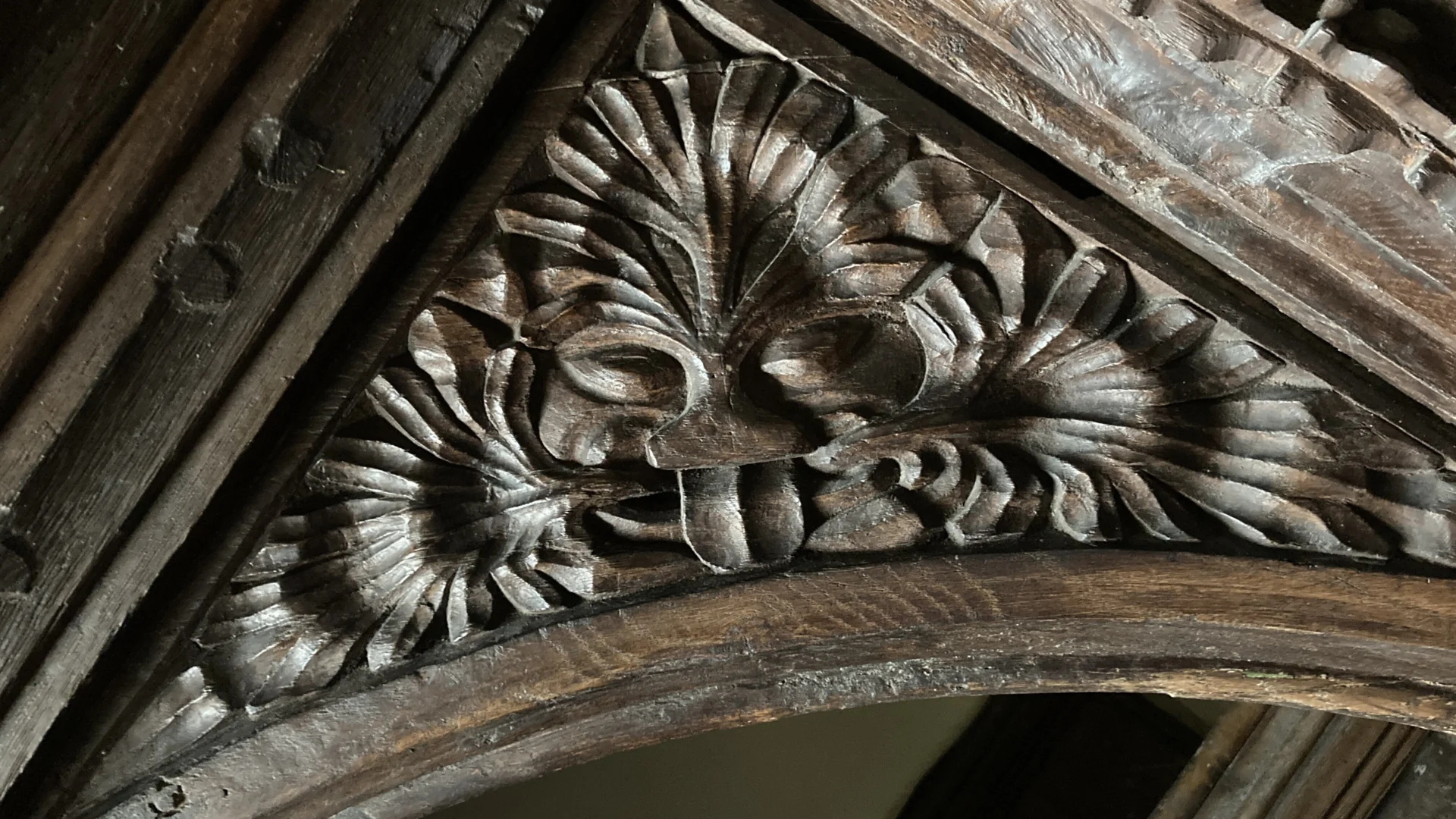 Wood carving under gallery of green man