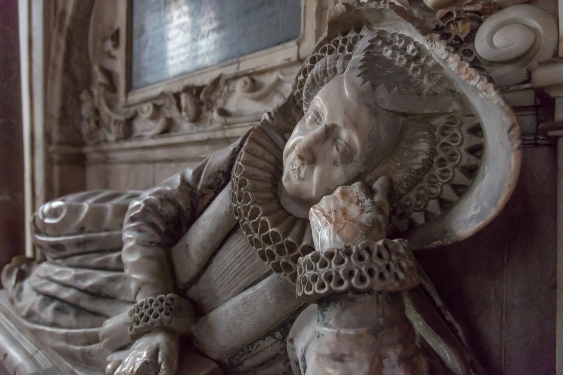 Marble carving of human figure adorning an internal monument