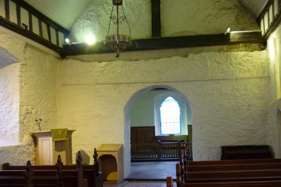 Interior of the church with white walls and sunlight coming through the window