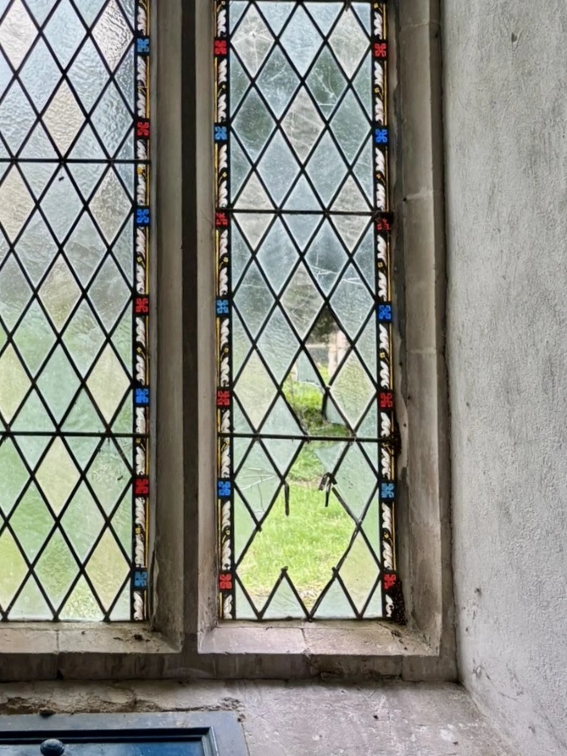 Vandalised historic window at St Mary's Church in Washbrook.