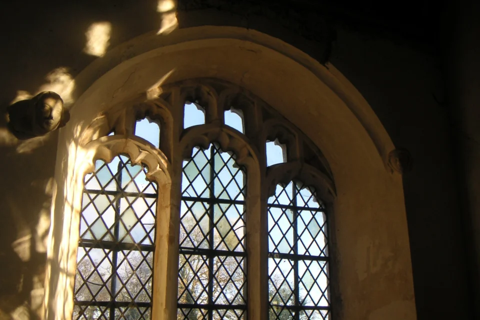 Sun light coming through the window framed in carved stone