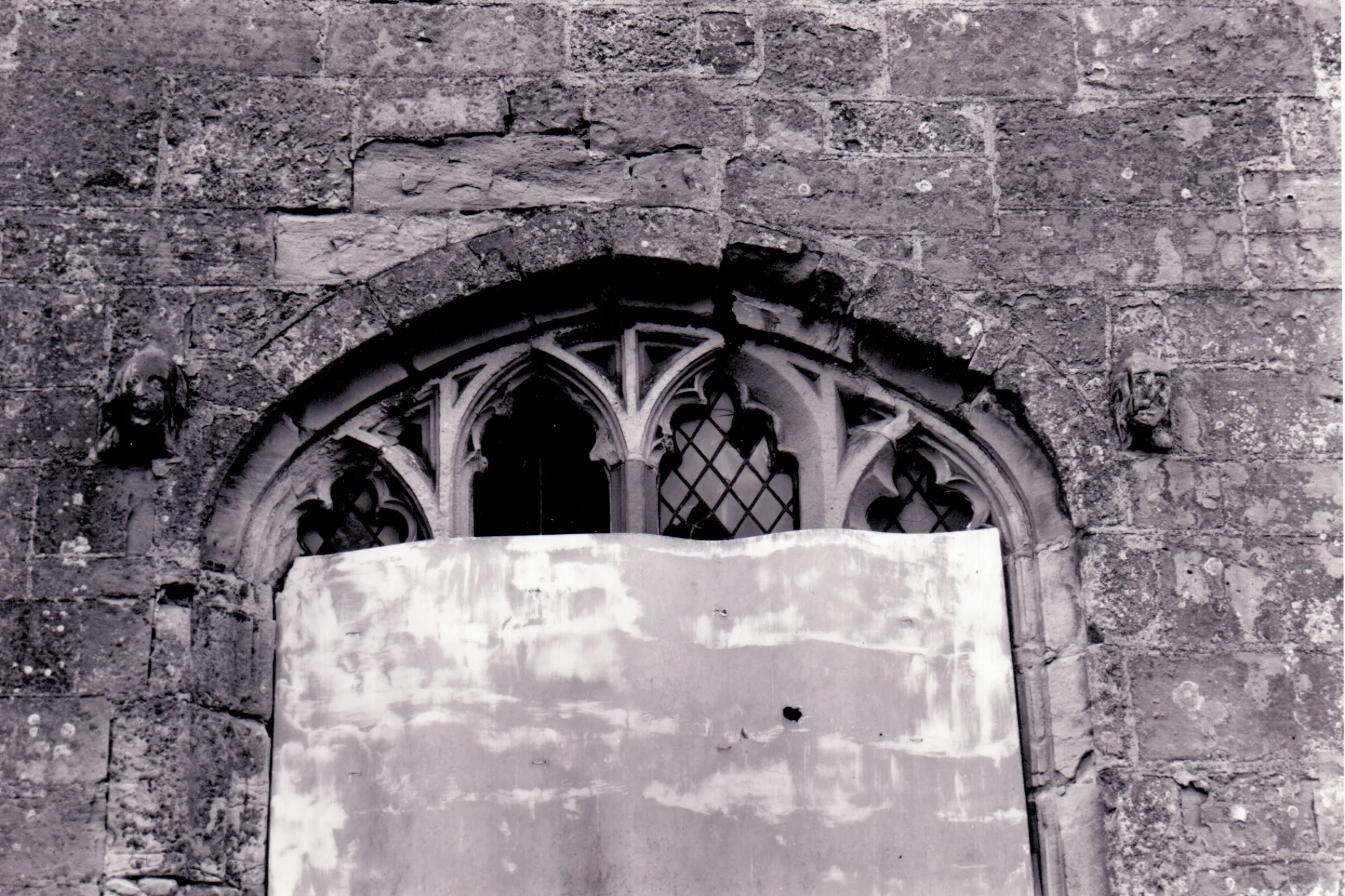 A window of St Peters' Church, Wolfhamcote boarded in the 1960s following vandalism.