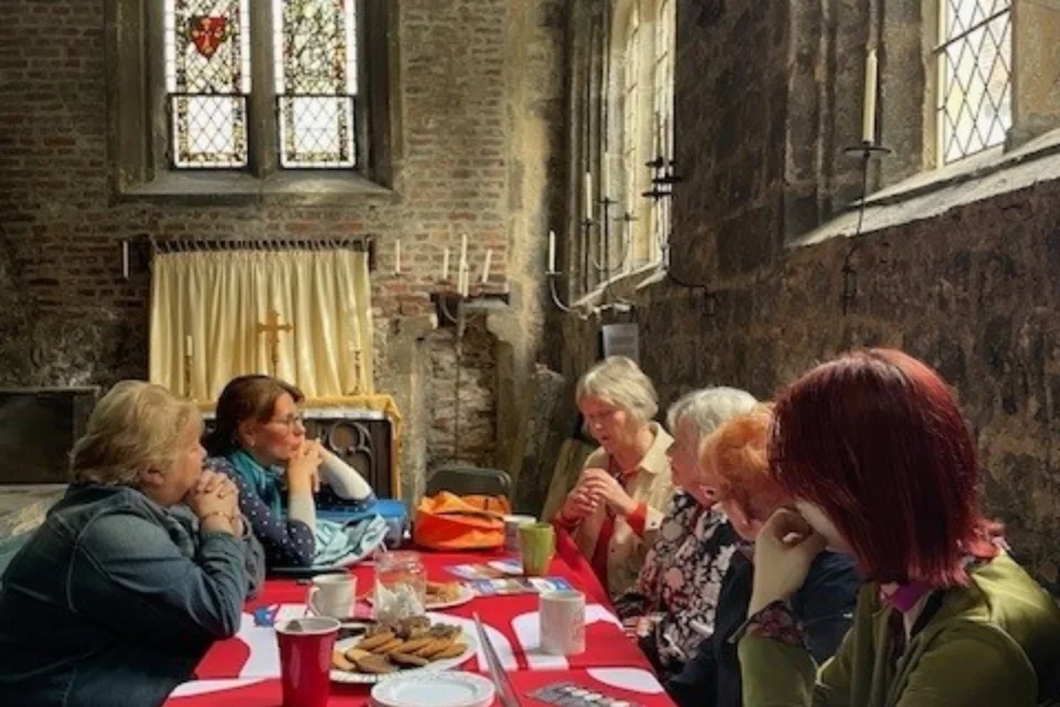a table of 5 people gather in York's sunken chapel to hear about best practice in accessibility.