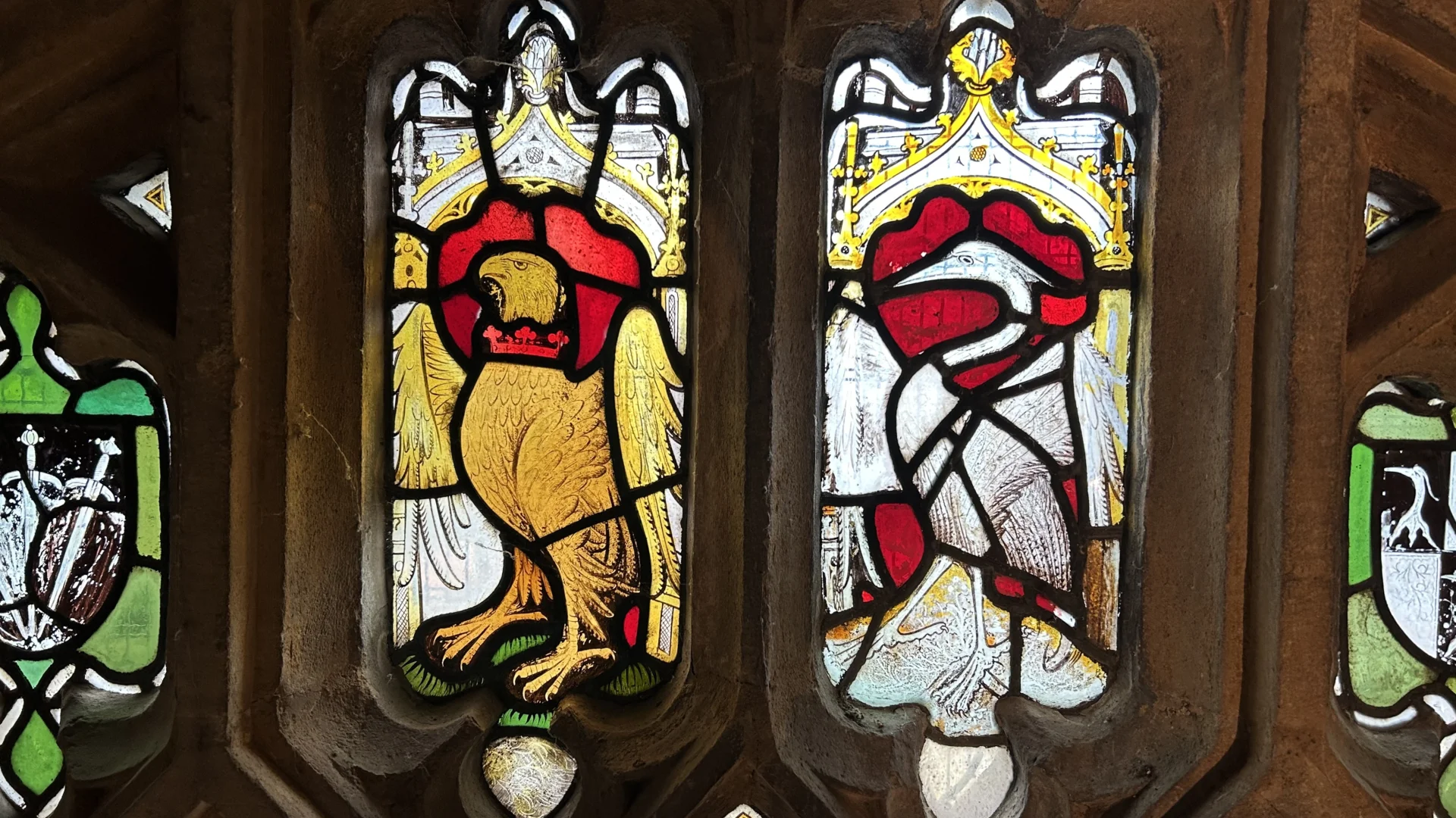 Medieval east window showing heron and falcon