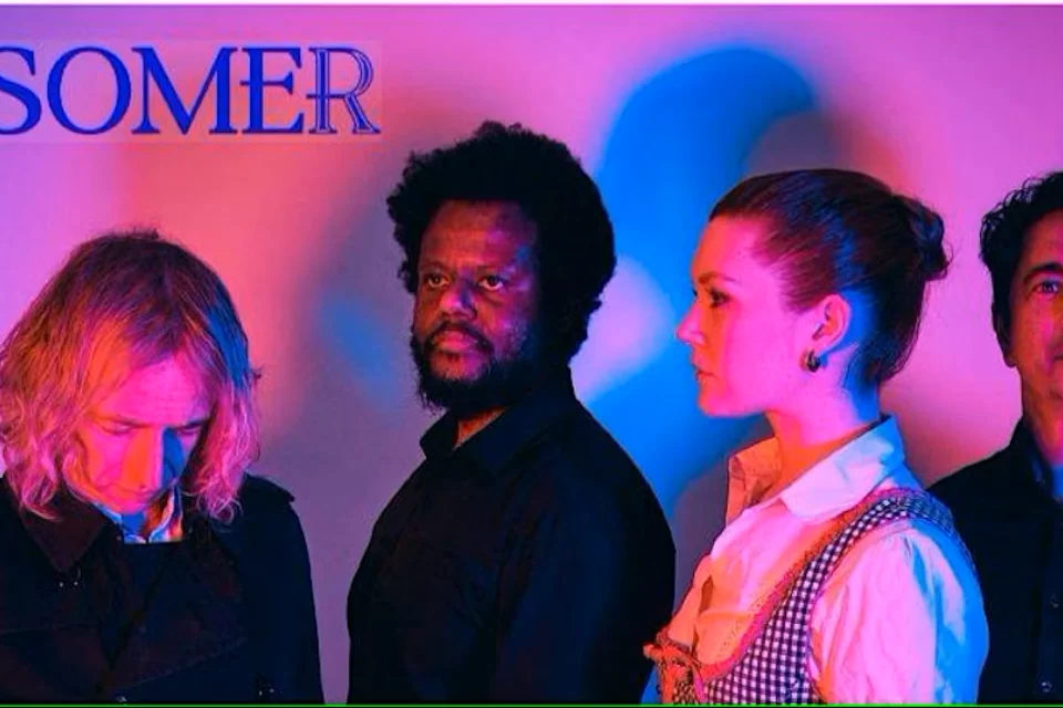 Image of SOMER band showing 4 people on pink lit background