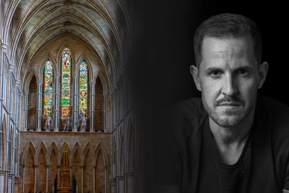 first image is the inside of a beautiful cathedral (West Window), with the camera pointing up the isle towards and multi coloured window., arches frame the left and right of the shot. There is also a black and white mage of a man with tatoos, staring directly at the camera.