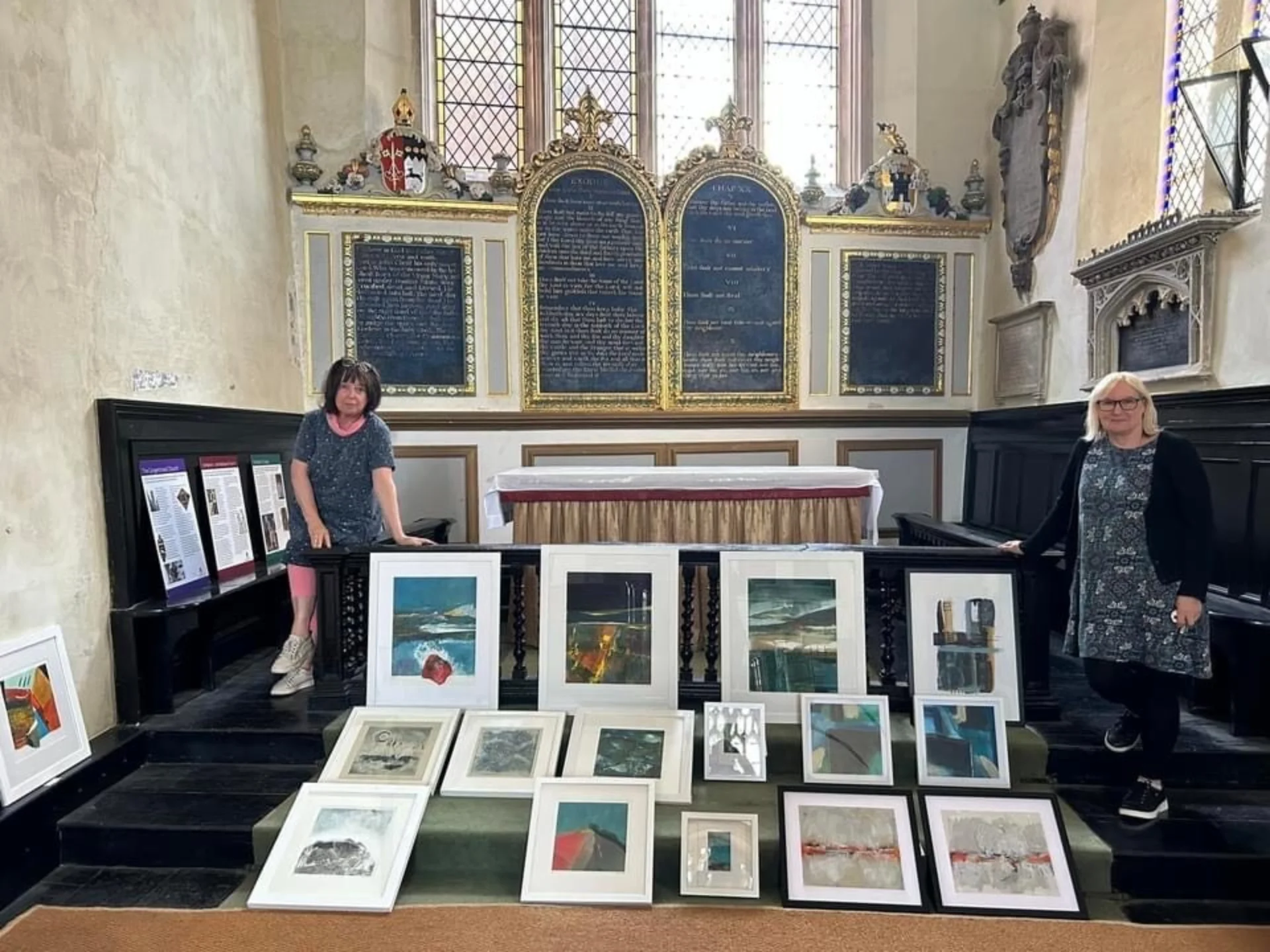 Artists Val Jones and Ray with some of their work inside St. Martin's Exeter