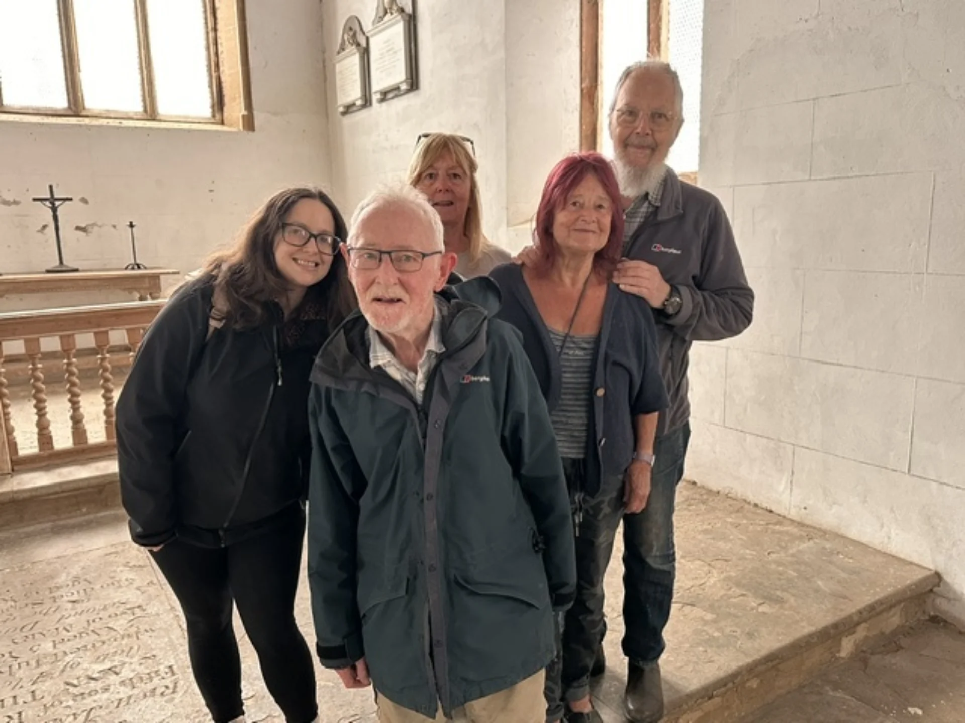 5 people from the Friends of Wolfhampcote posing for a photograph inside Wolfhampcote church