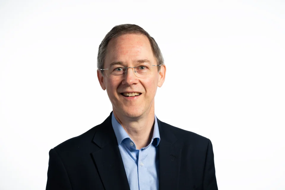 A man in a shirt and suit jacket