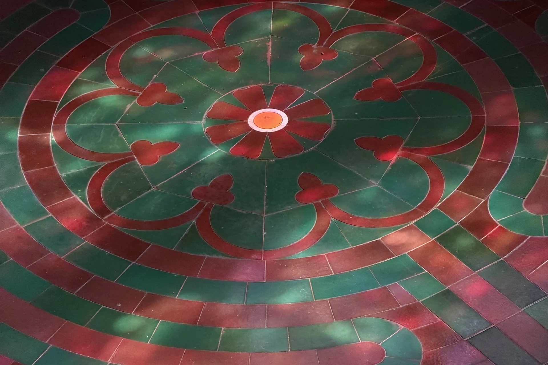 green and brown tiles lead the way to the centre of a labyrinth