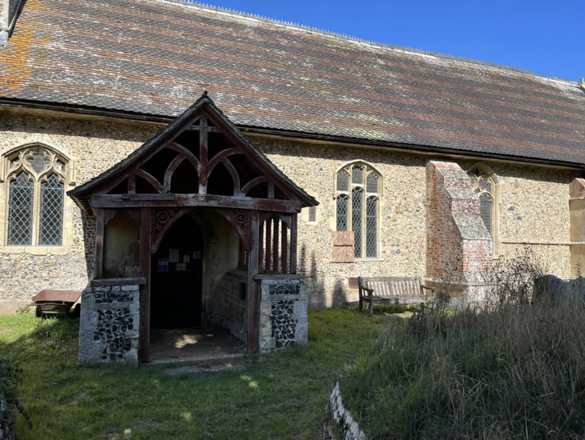 A tranquil setting for a stone church with wooden framed porch