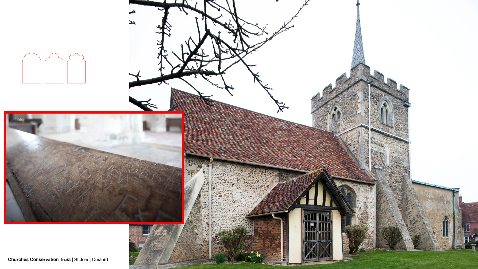 Exterior of church with red toned stone, red roof and green spire on bell tower with crenelations,