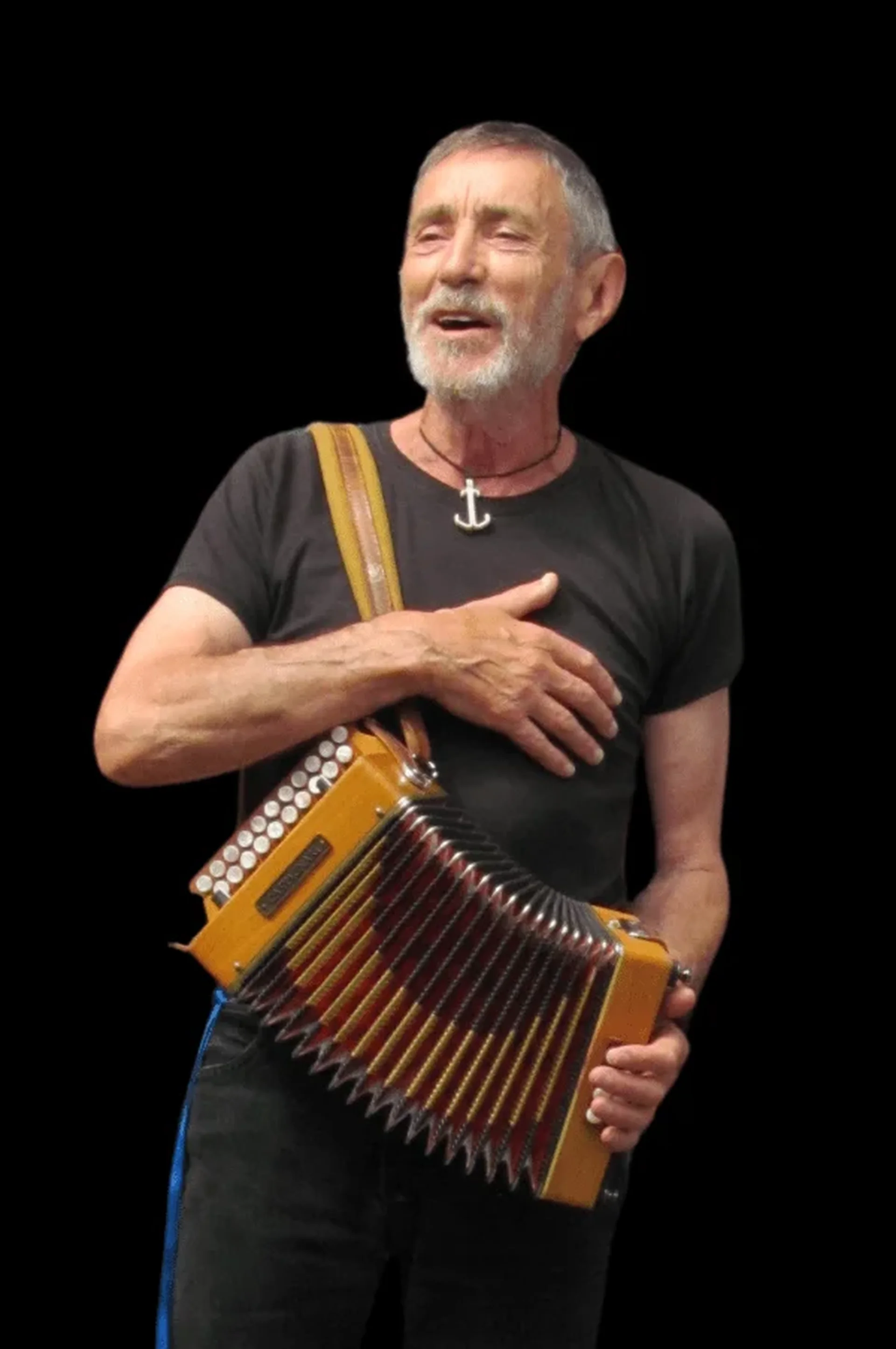 Older white man with beard singing and playing accordion
