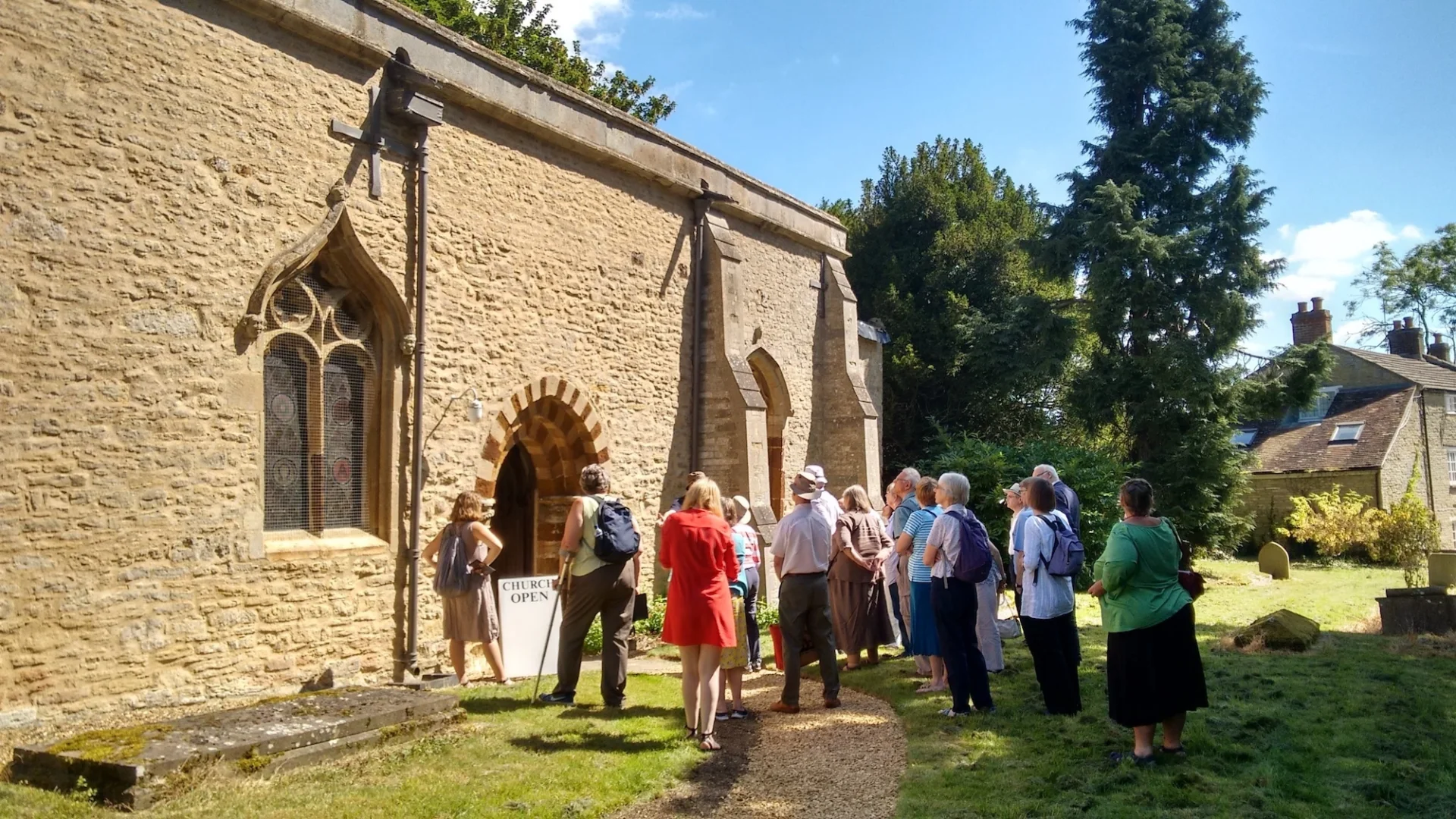 A group of visitors outside a historic church
