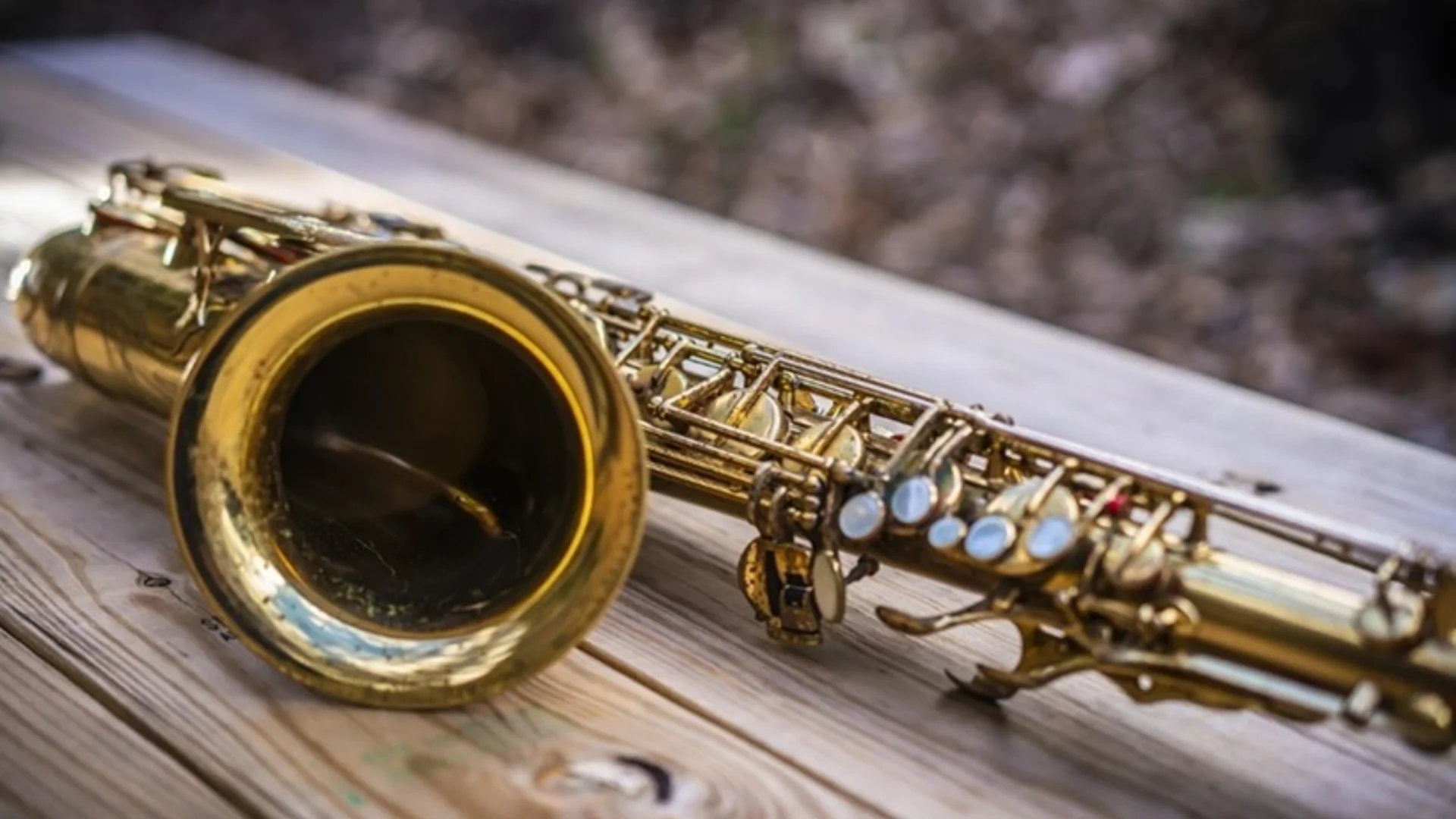 saxophone laying on a wooden table