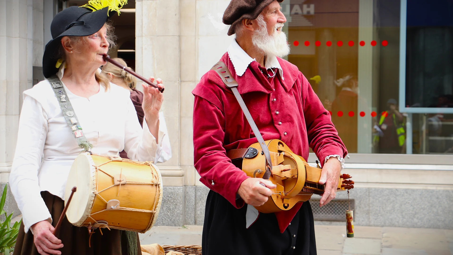 Two musicians in historical costume playing historical instruments