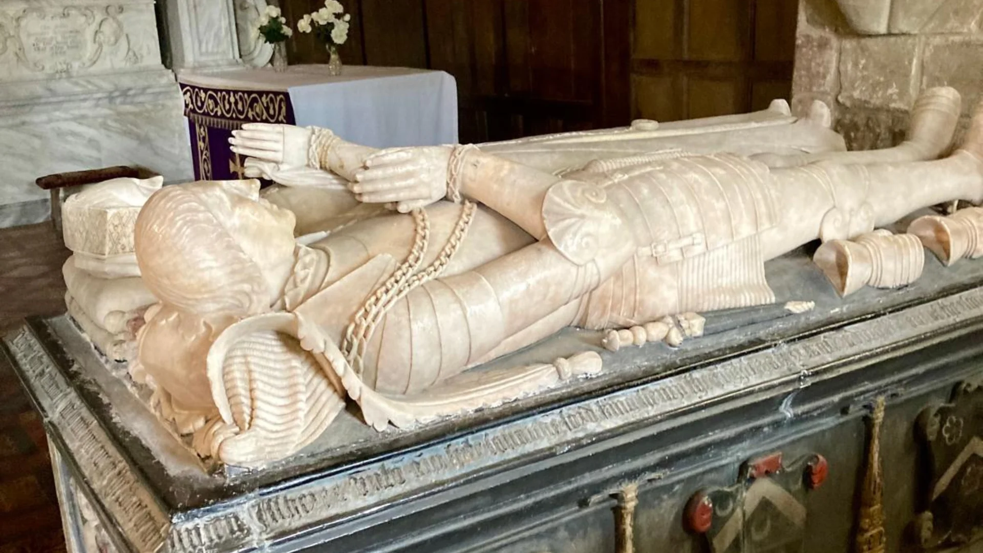 Chest tomb with statues of reclining knight and lady, inside church