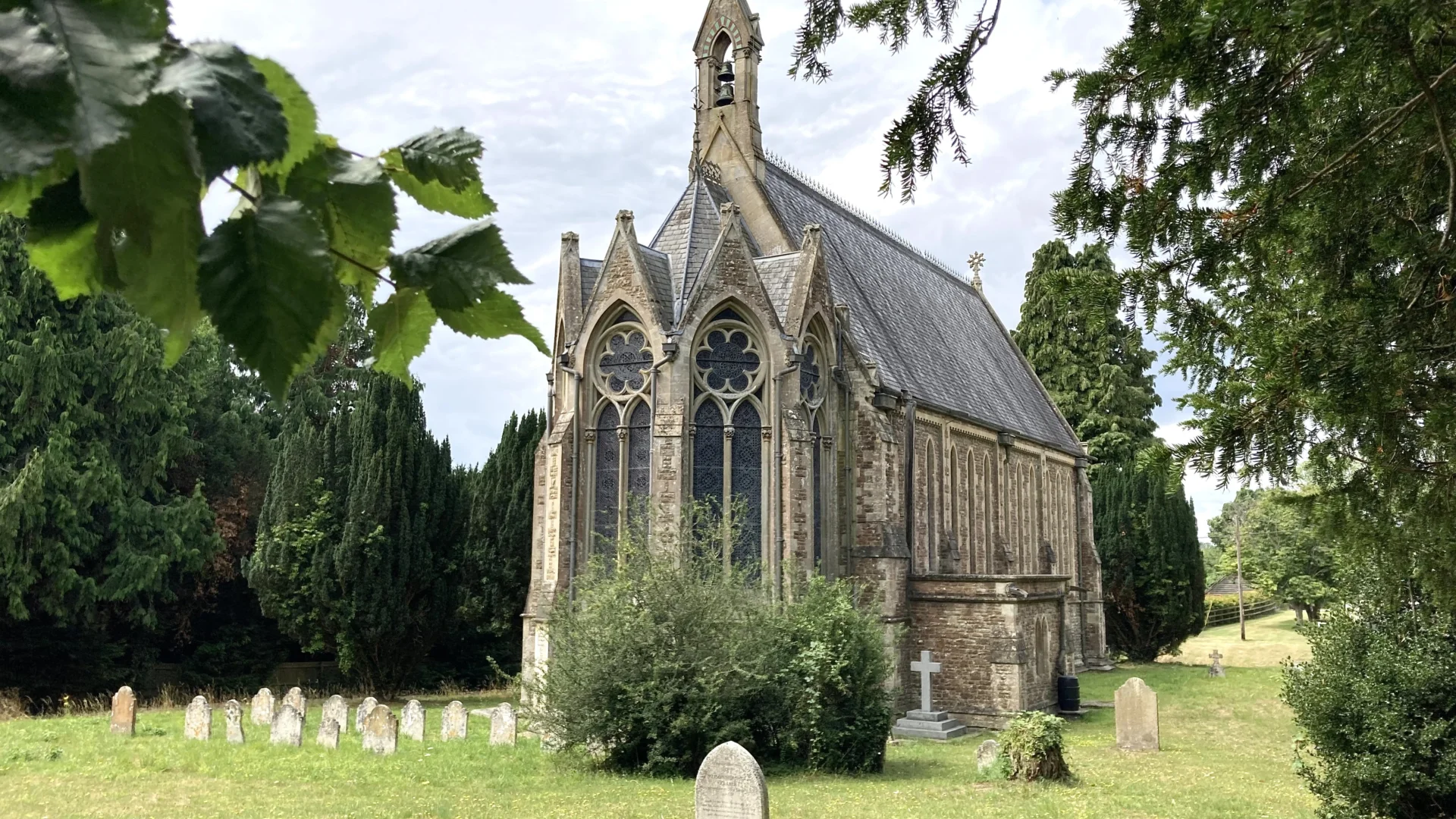 St Marys Itchen Stoke Church and churchyard framed by trees
