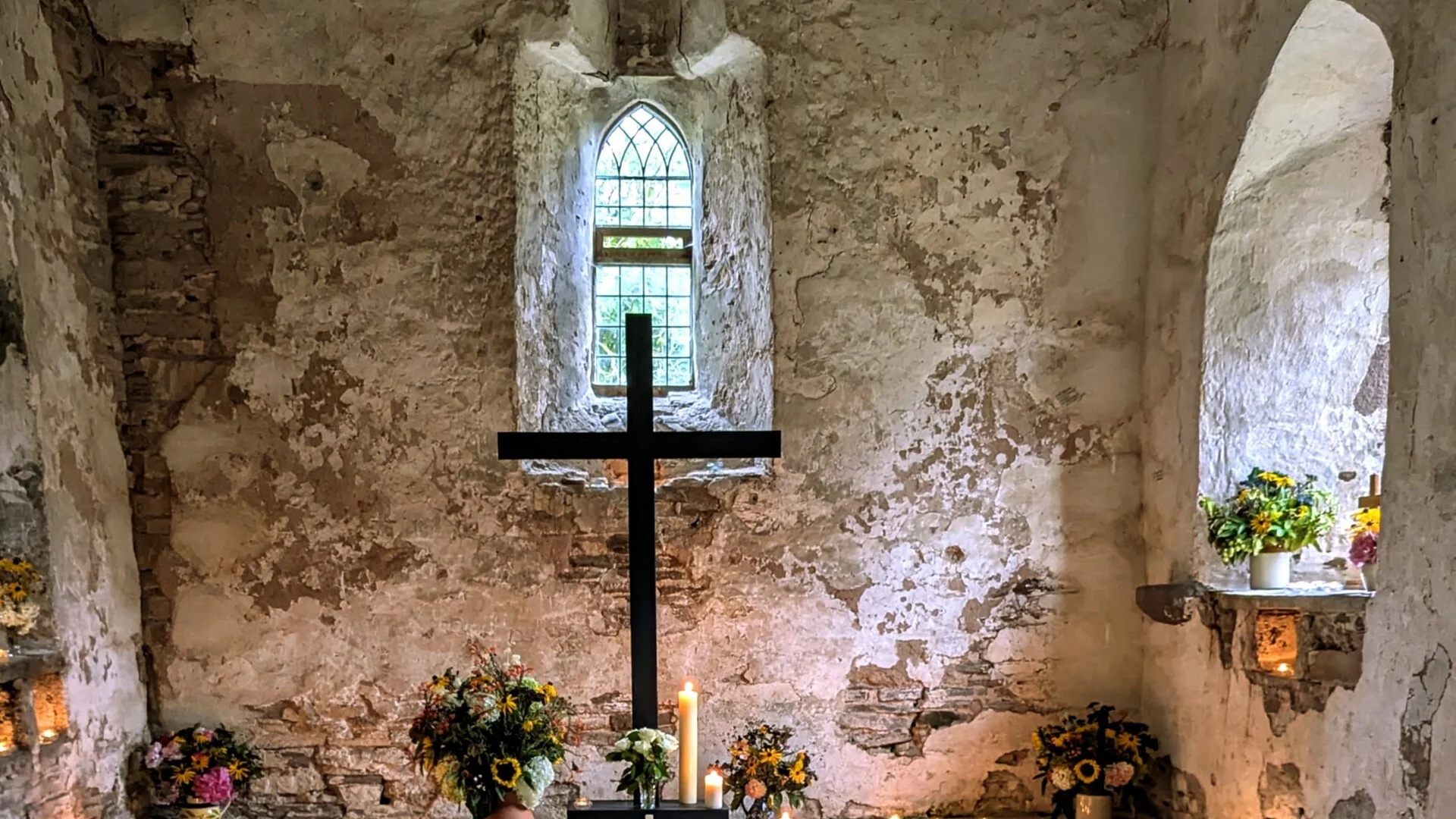Interior of Lower Sapey decorated cross with flowers and candles